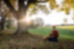Wendy and her dog cuddle under a tree after walking on a lovely farm in the Bluegrass
