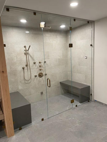 Curbless tile shower with sauna featuring 24x48 floor tile and 12x24 wall tile in Windsor Colorado