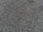 Close-up of 9.5mm crusher dust showing fine, dark grey crushed aggregate with small stone fragments.