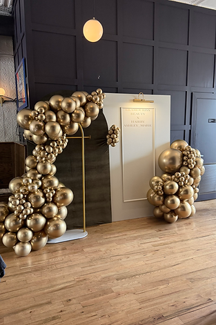 Luxury gold balloon decor paired with a personalized event backdrop for an elegant vendor event