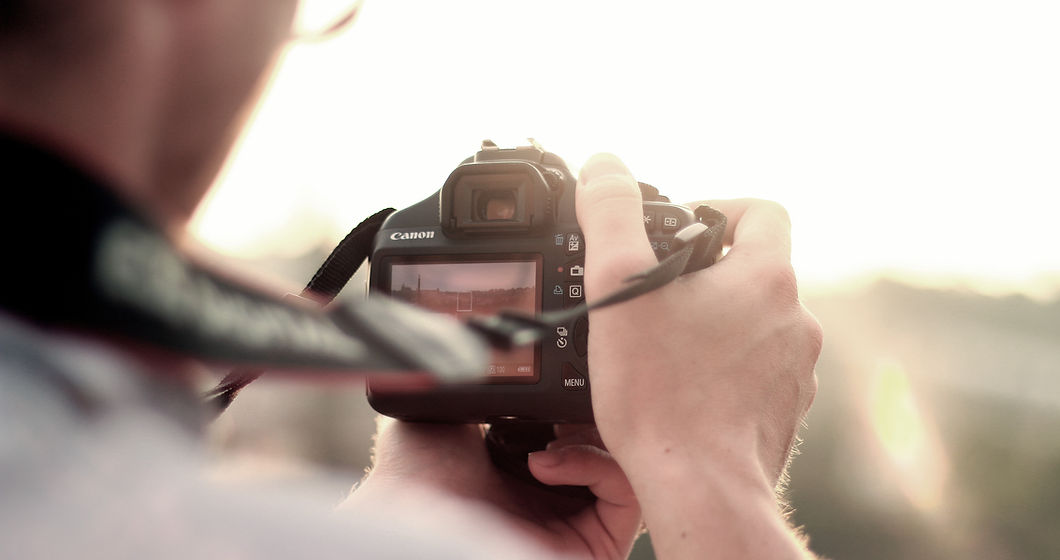 man camera taking photo photographer