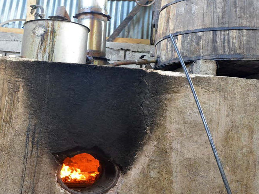 Distillation happens in small pot stills fed by direct wooden-fire.jpg