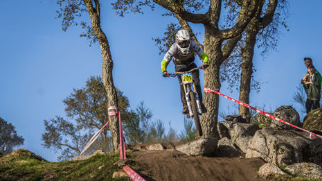 MTB Jumps, a rider jumps between the trees during a downhill race in Portugal