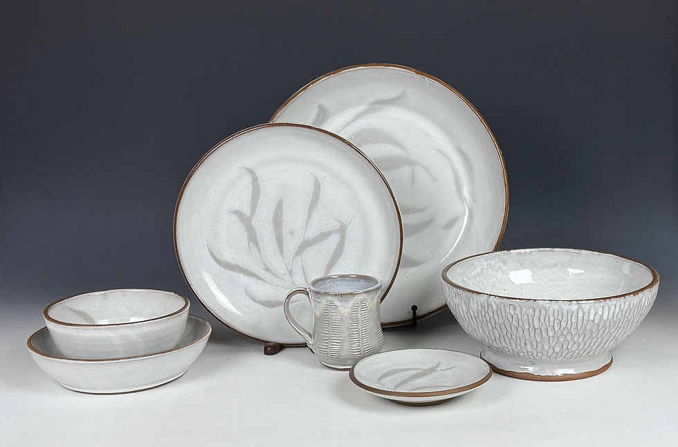 dinnerware set featuring two large plates three bowls one small plate and cup with light white wisps
