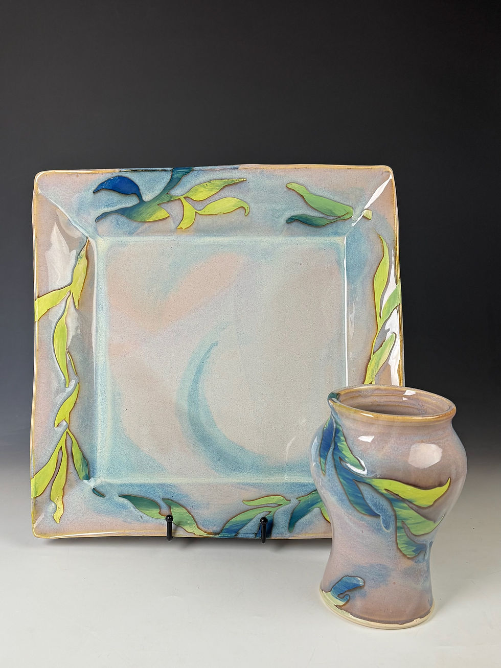 square plate and cup with blue green wisps throughout