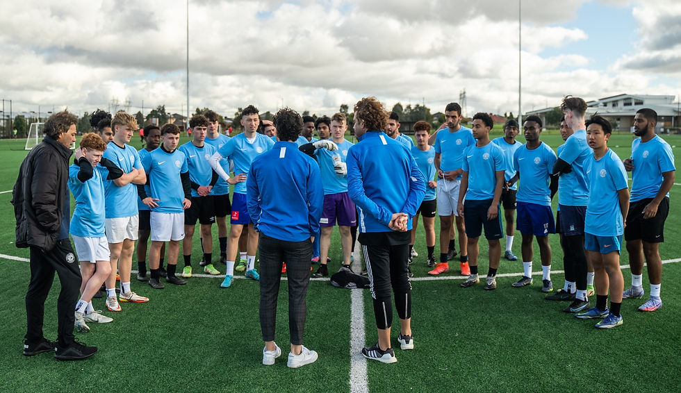 Group of football players receiving instructions during an Elite Football trial from Alan Deriard and Maurice Deriard