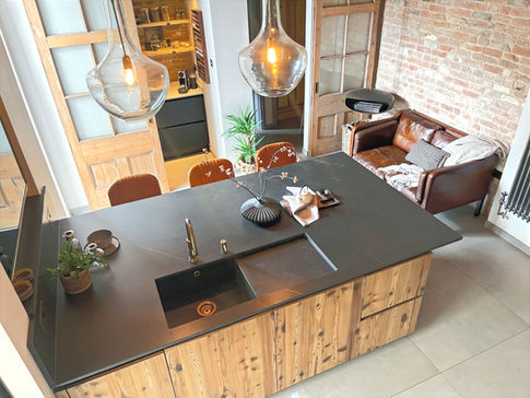 a kitchen with wooden cabinets and a black sink