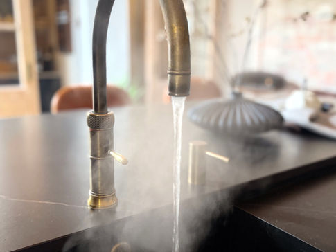 a kitchen faucet with steam coming out of it
