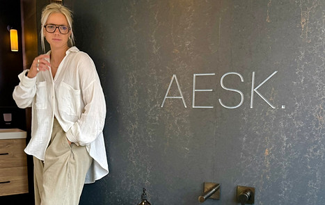 beth askew in front of AESK sign in AESK showroom Lincoln