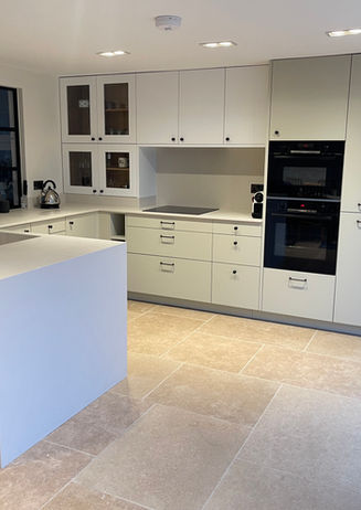 a kitchen with custom colour cabinets and a black bosch oven