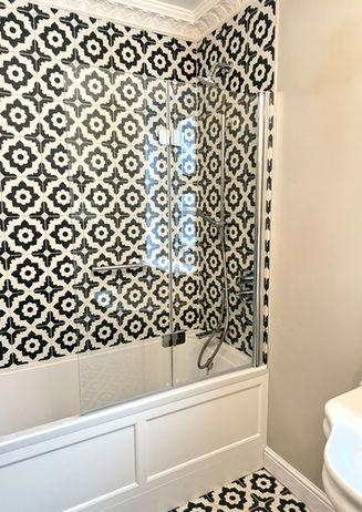 Bathroom with black and white patterned tiles.