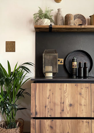 a kitchen with wooden cabinets and a plant on the counter