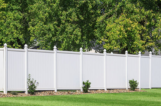 Constructed and painted white fence around a house