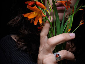 woman holding plant while wearing Irish Handmade Jewellery