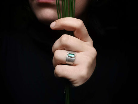 A close-up shot of beautiful custom silver ring highlighting intricate designs.