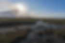 Dünenlandschaft mit Wasserlauf unter Sonne auf Norderney