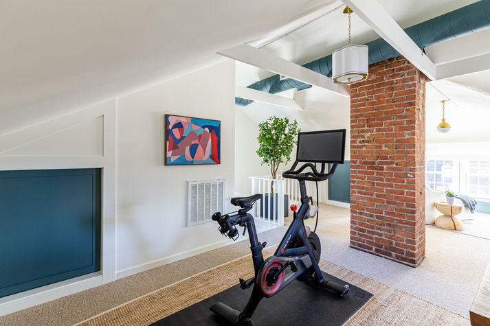 A third floor office suite with a Peleton workout area.
