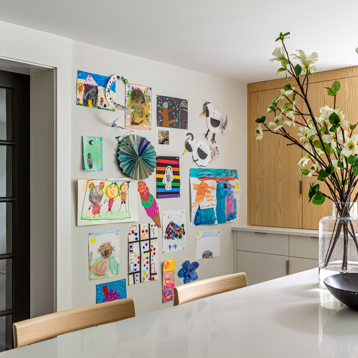 Children’s artwork hanging on the walls of a kids playroom.