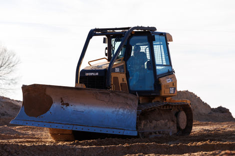 Caterpillar equipment driving around.