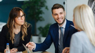 Three young business executives learn to speak corporate English
