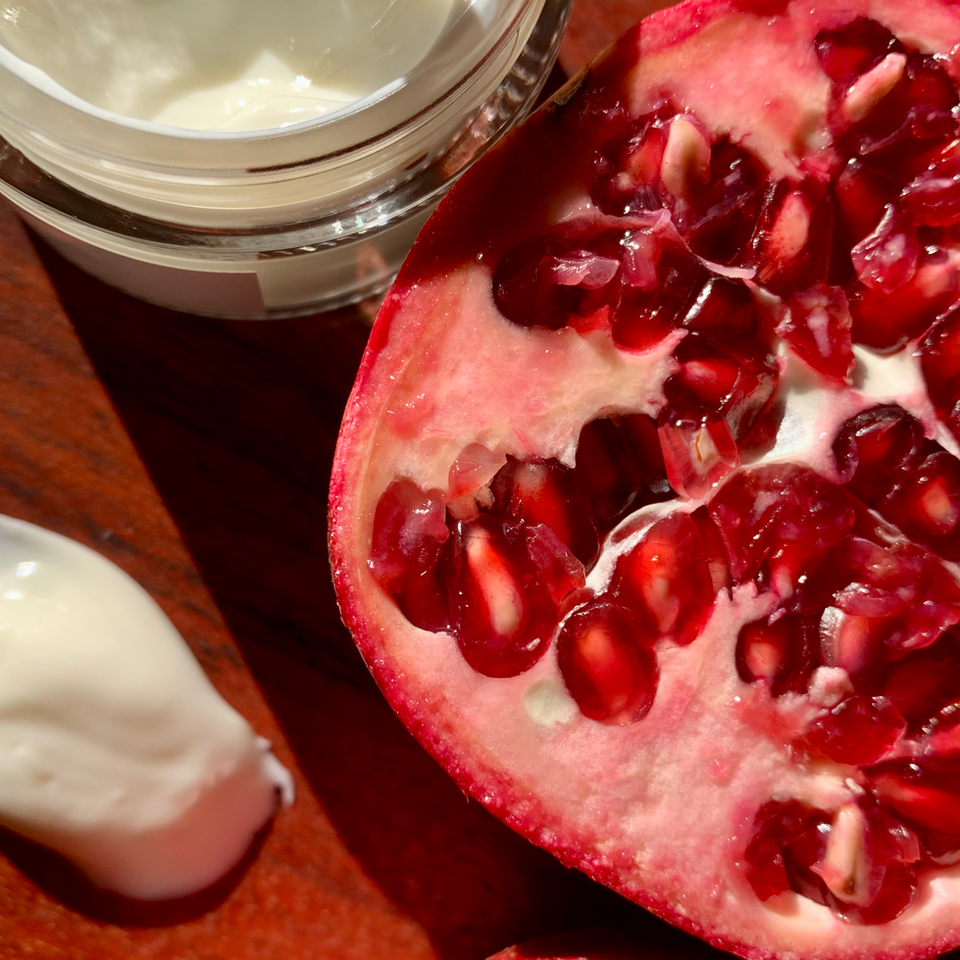 flat lay sliced pomegranate repair cream for dry, sensitive skin