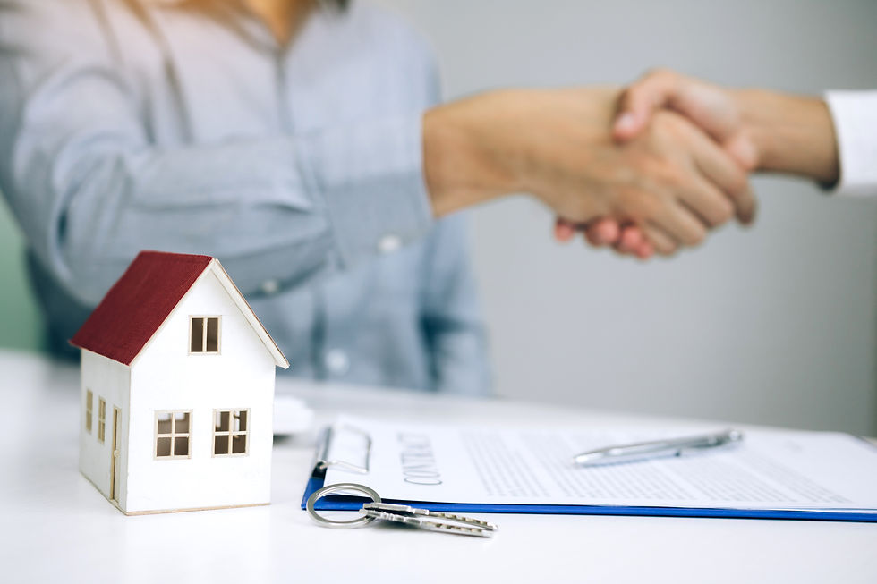 Home sales agents and buyers work on signing new homes and shaking hands..jpg