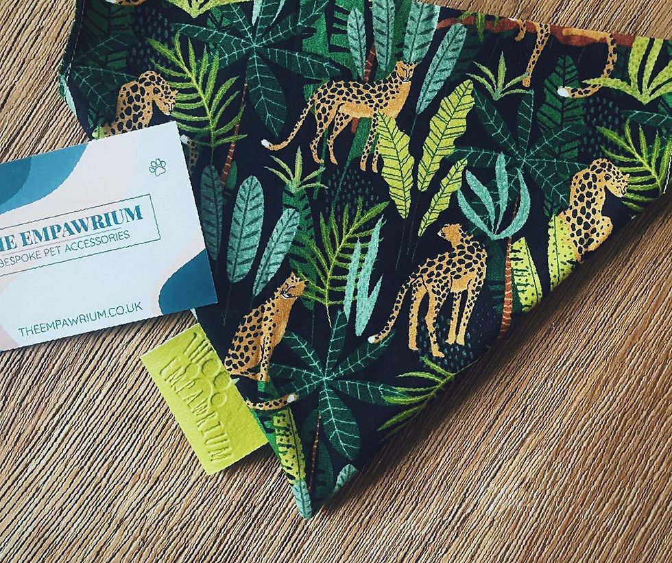 a black pet collar bandana featuring aa cheetah and leaf pattern