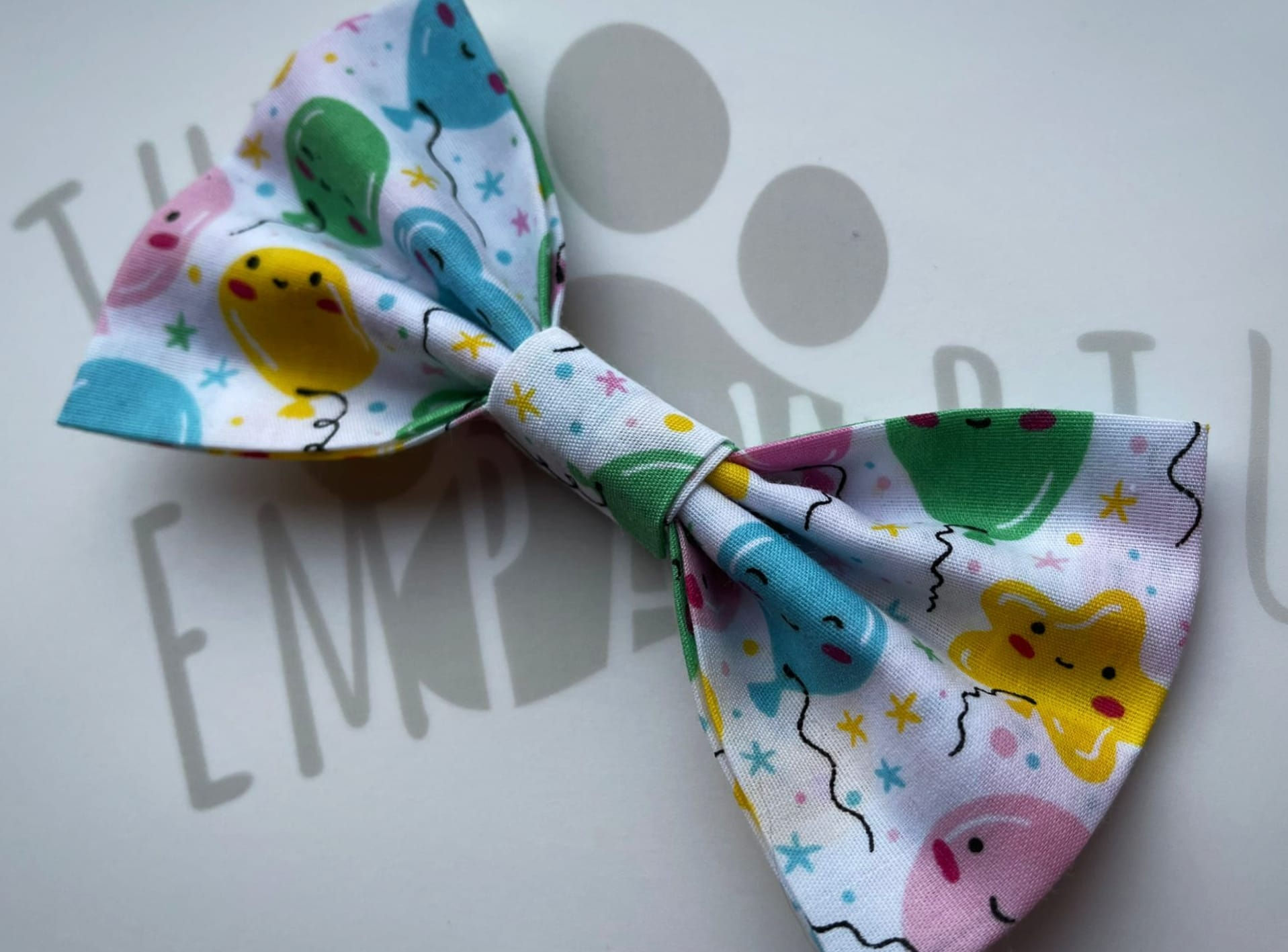 A pet birthday collar bow tie with a balloon pattern on it