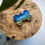 Thumbnail: A bone shaped pet tag in the design of the beach