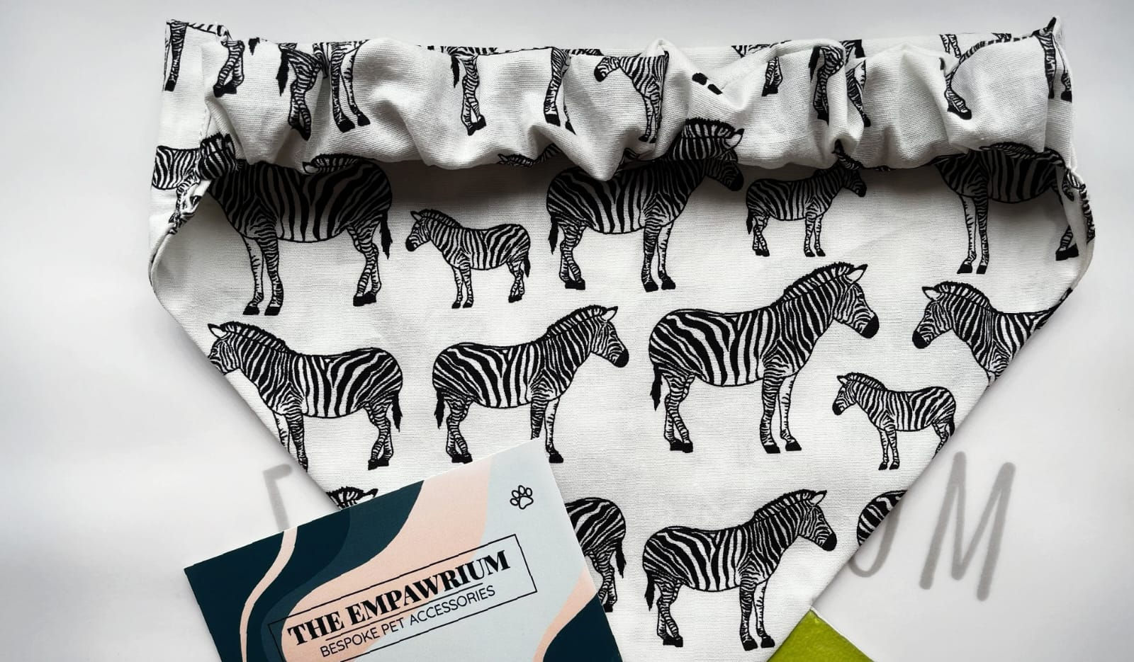An elastic pet bandana with zebras on it