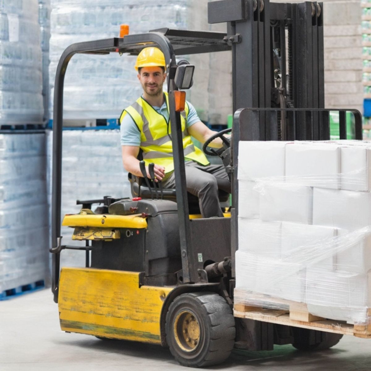Forklift operator in a warehouse.