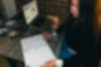 Eye-level view of a small business owner working on a marketing plan at a cozy desk