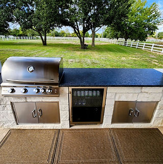 Outdoor Kitchen with Granite Countertop and Gas Grill