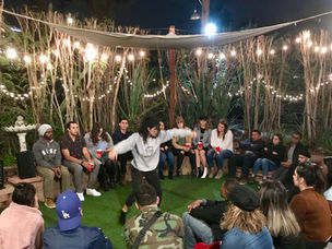 performer in front of crowd at hostel