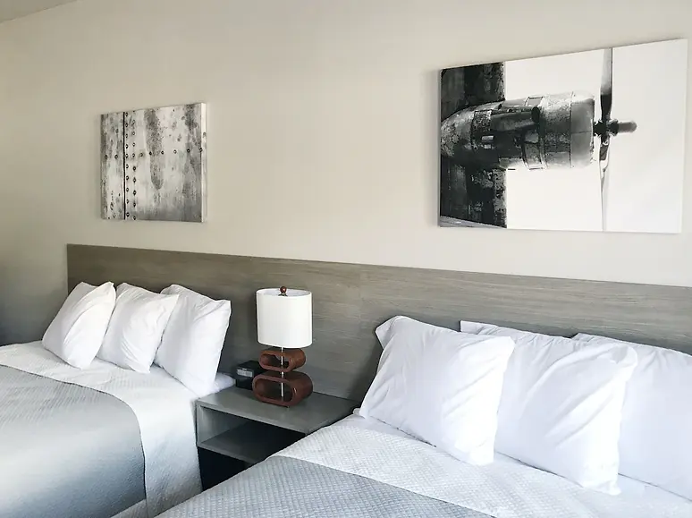 beds with two pictures hanging above 