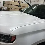 White truck hood cleaned and prepped with wipers up before ceramic coating application at Mack2Steam in La Crosse WI