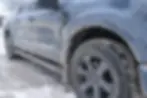 Road salt buildup covering a pickup truck during a Wisconsin winter, showing why ceramic coating maintenance is important.