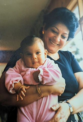 Meet the Founder: Sarah as a baby being lovingly held by her mother.