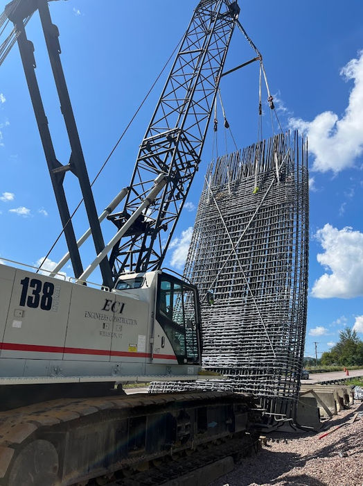 Crane raising the pier rebar cage into place