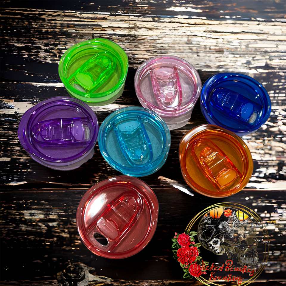 Colorful tumbler lids arranged on a wooden table, featuring various vibrant hues. WBK
