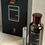 Miniatura: Vista frontal superior frasco perfume Bharara King de 100ml junto a su perfumero pequeño y caja original
