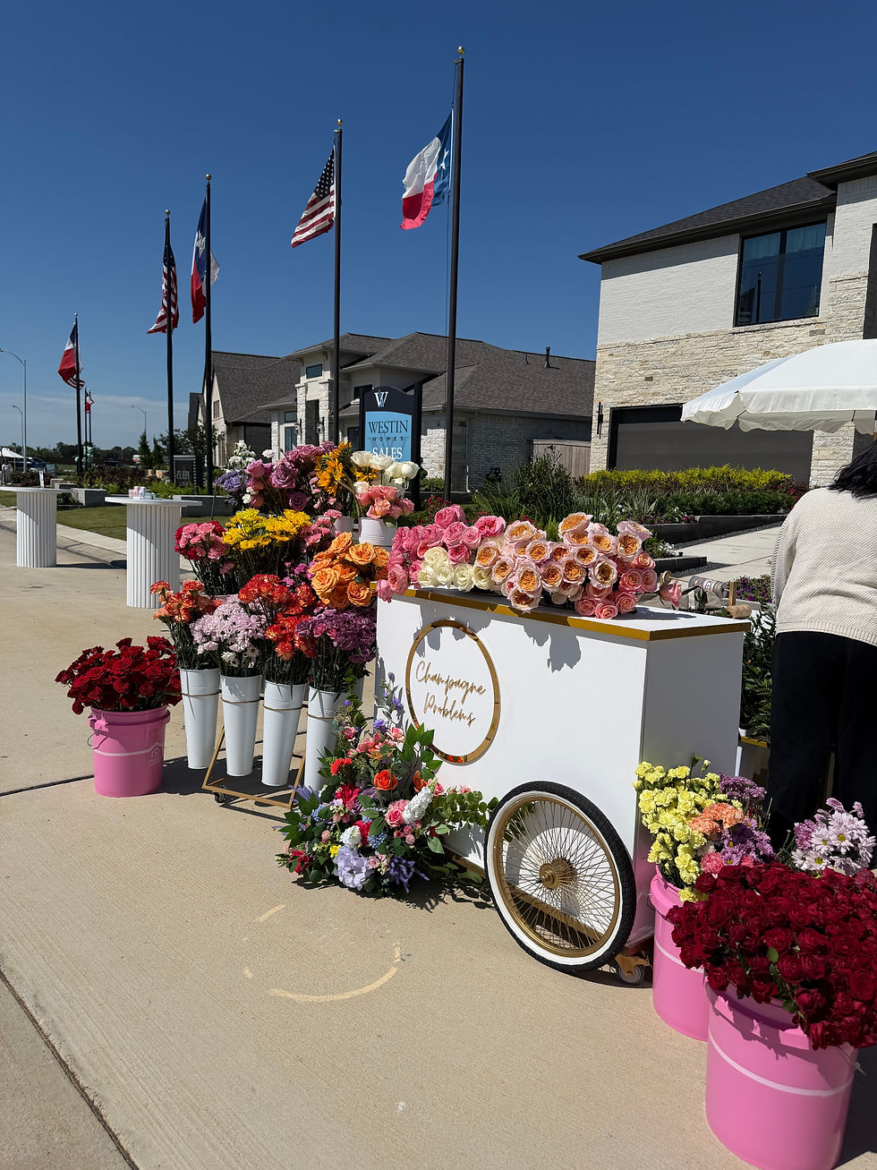 Close-up view of a guest arranging a colorful bouquet at a flower bar