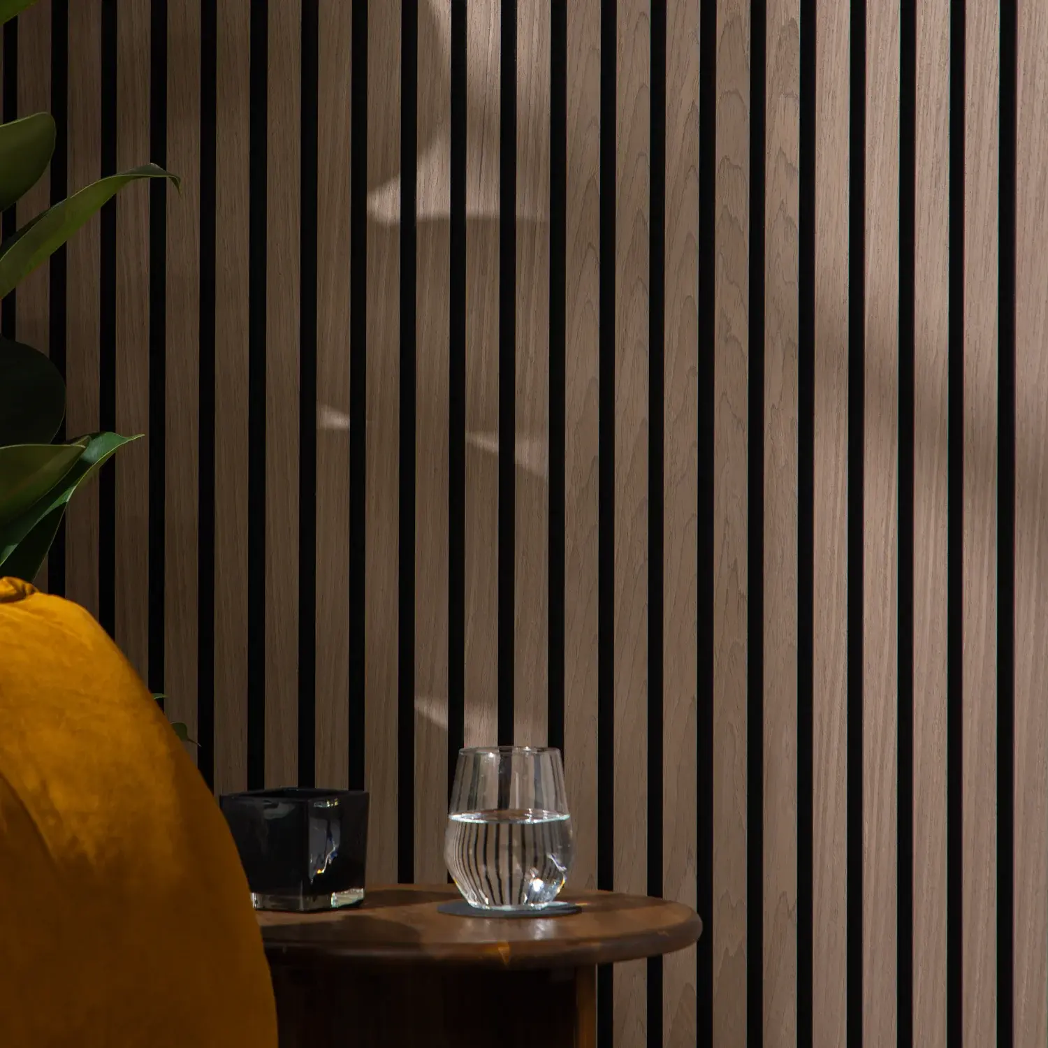 Walnut slatted wall panelling in a modern room setting.