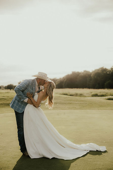 bride and groom kissing on a golf course at sunset. Mckinney, TX wedding photographer