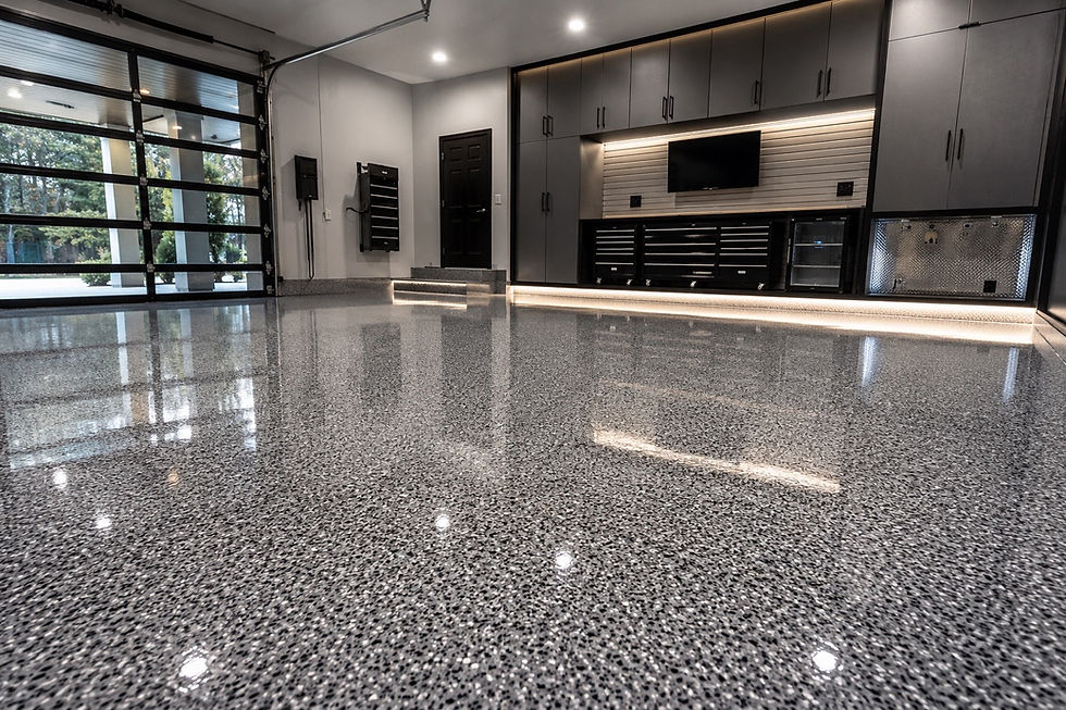 Glossy grey flake concrete coatings in a modern garage.