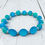 Thumbnail: Sea glass blue beaded bracelet with frosted matte beads and silver accents on a whitewashed coastal wood background.