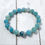 Thumbnail: Amazonite gemstone stacking bracelet from the Coastal Collection with pale blue beads on beach-inspired wood surface.
