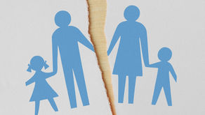 Blue paper cutout family of four, split by a jagged tear in the center on a white background, symbolizing separation or divorce.