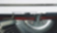 Close-up of a red typewriter with the words "something worth reading" typed out.