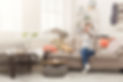 Desperate helpless woman sitting on sofa in messy living room. Young girl surrounded by ma